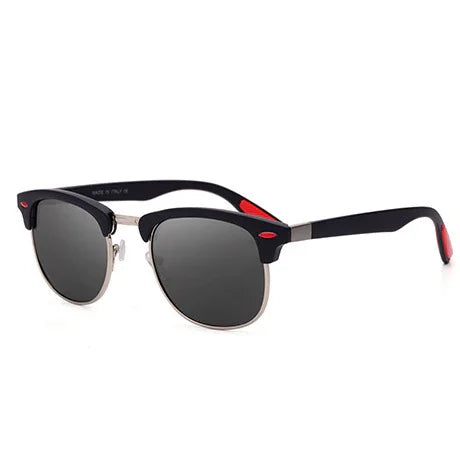 Stylish black and silver sunglasses with dark lenses and red accents on white background