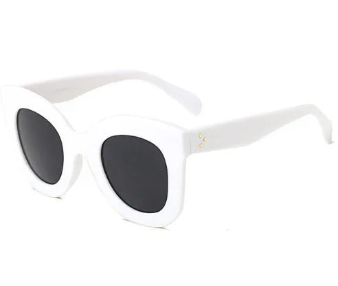 White oversized cat-eye sunglasses with black lenses and subtle gold accents on temple