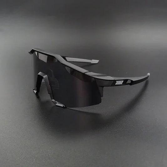 Black wraparound sports sunglasses with dark lenses on a matte black surface