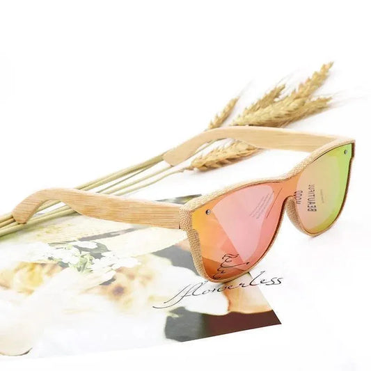 Wooden frame sunglasses with gradient mirrored lenses, styled with dried wheat and floral print