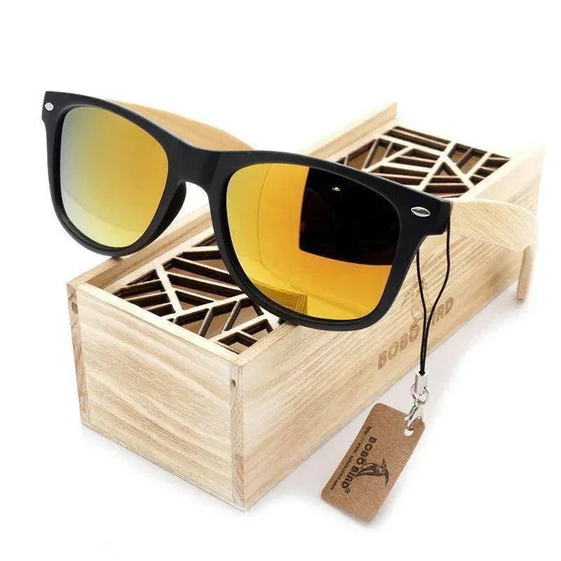 Black-framed sunglasses with yellow mirrored lenses in a wooden box, ideal for men and women