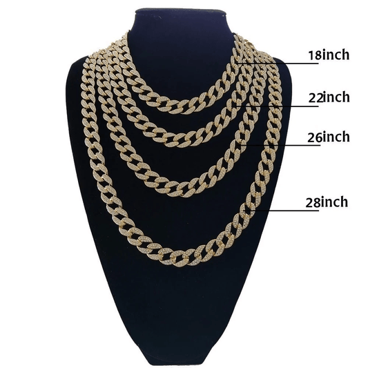 Four gold Cuban chain necklaces with diamond accents displayed in 18, 22, 26, and 28 inch lengths on black stand