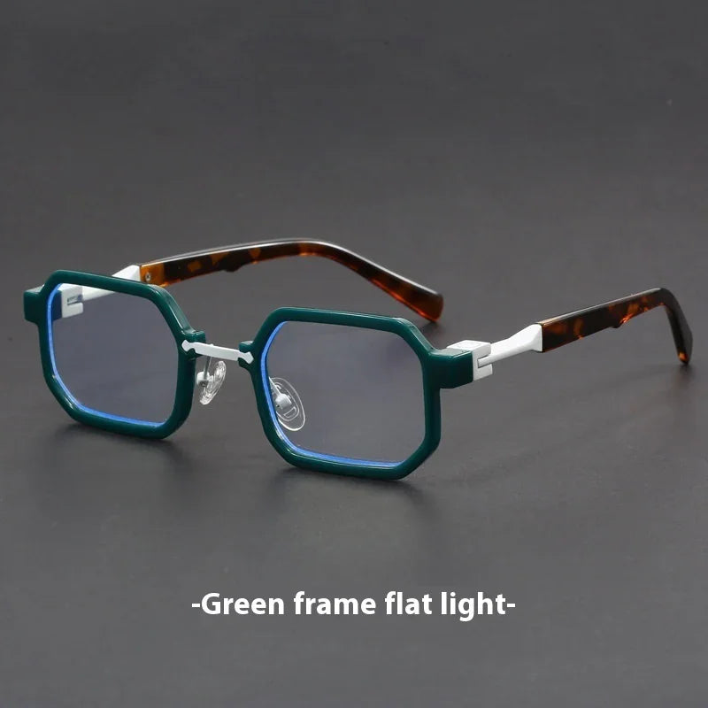 Green octagonal frame eyeglasses with tortoiseshell temples on a dark surface