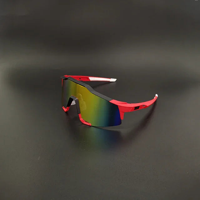 Red sports sunglasses with rainbow mirrored shield lens on black background
