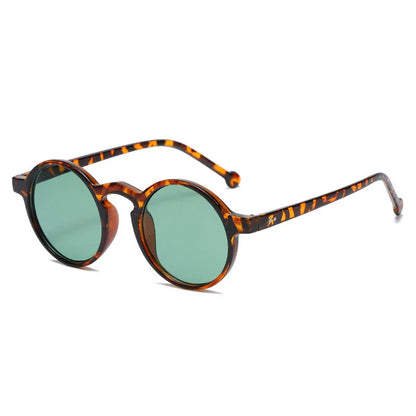 Round tortoiseshell frame sunglasses with green tinted lenses on white background