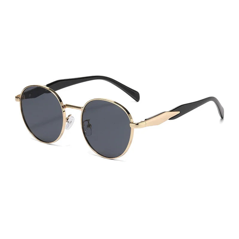 Round black lens sunglasses with gold metal frames and black temple tips on white background
