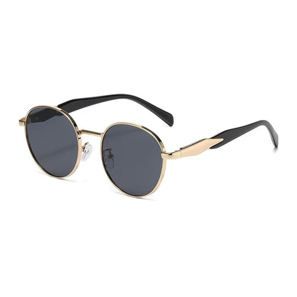 Round black lens sunglasses with gold metal frames and black temple tips on white background