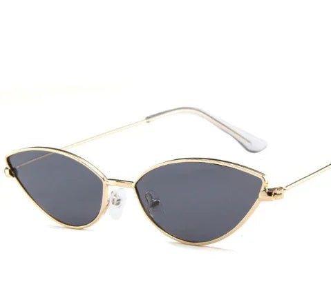 Sleek cat-eye sunglasses with thin gold metal frame and dark tinted lenses