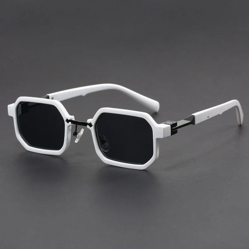 White octagonal frame sunglasses with black lenses on dark gray background