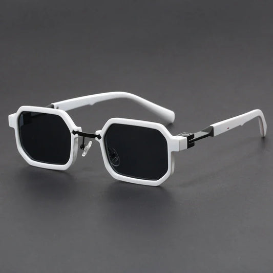 White octagonal frame sunglasses with black lenses on dark gray background