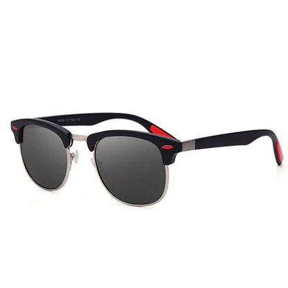 Stylish black and silver sunglasses with dark lenses and red accents on white background