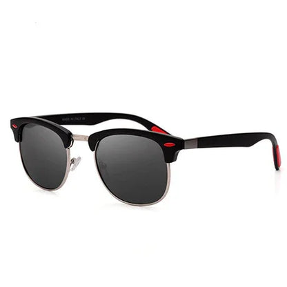 Stylish black half-frame sunglasses with dark lenses and red accents on white background