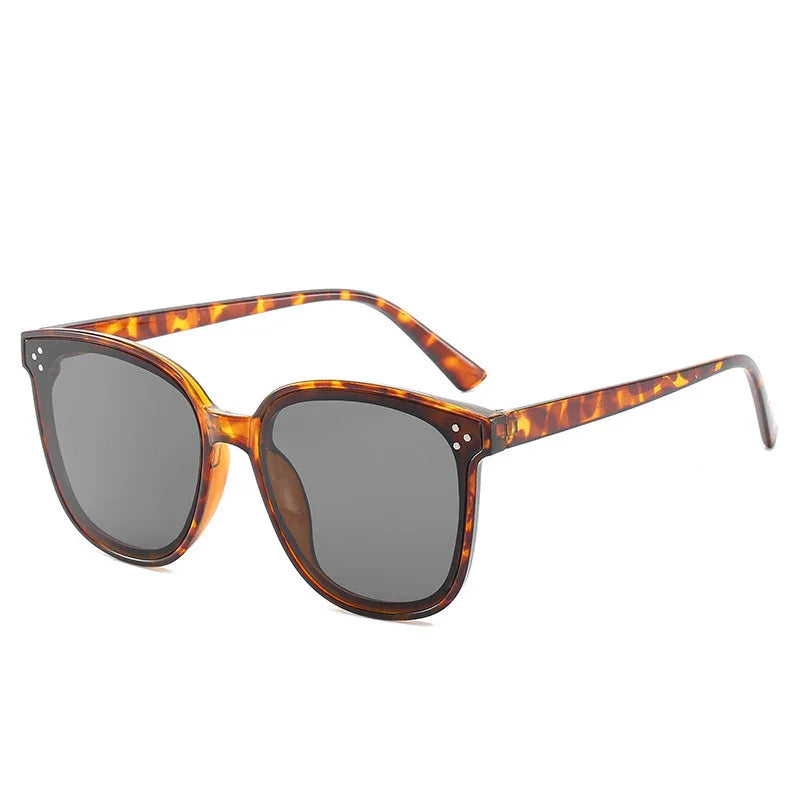 Tortoiseshell patterned sunglasses with dark lenses, classic square frame design