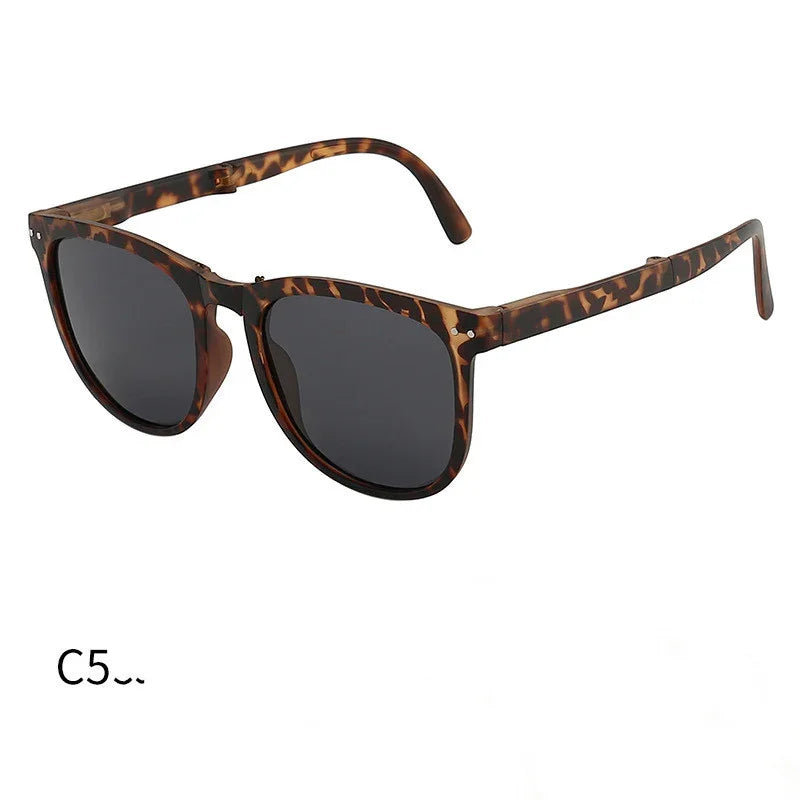 Tortoise shell patterned sunglasses with dark lenses in classic wayfarer style