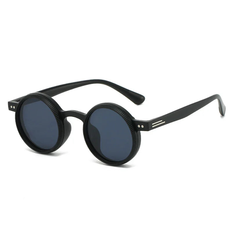 Black round sunglasses with thick frame and dark tinted lenses on white background