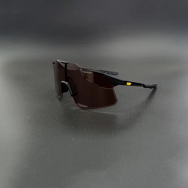 Modern black sport sunglasses with angular dark lenses on a plain dark background