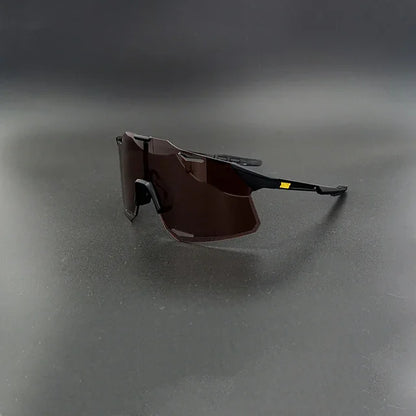 Modern black sport sunglasses with angular dark lenses on a plain dark background