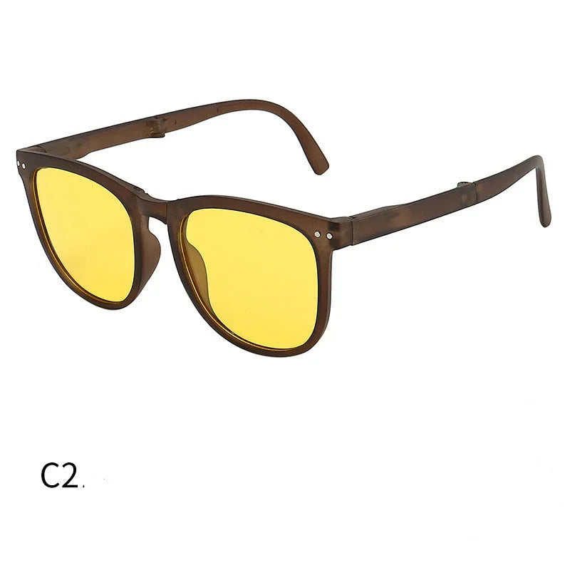 Brown transparent frame glasses with yellow tinted lenses on white background