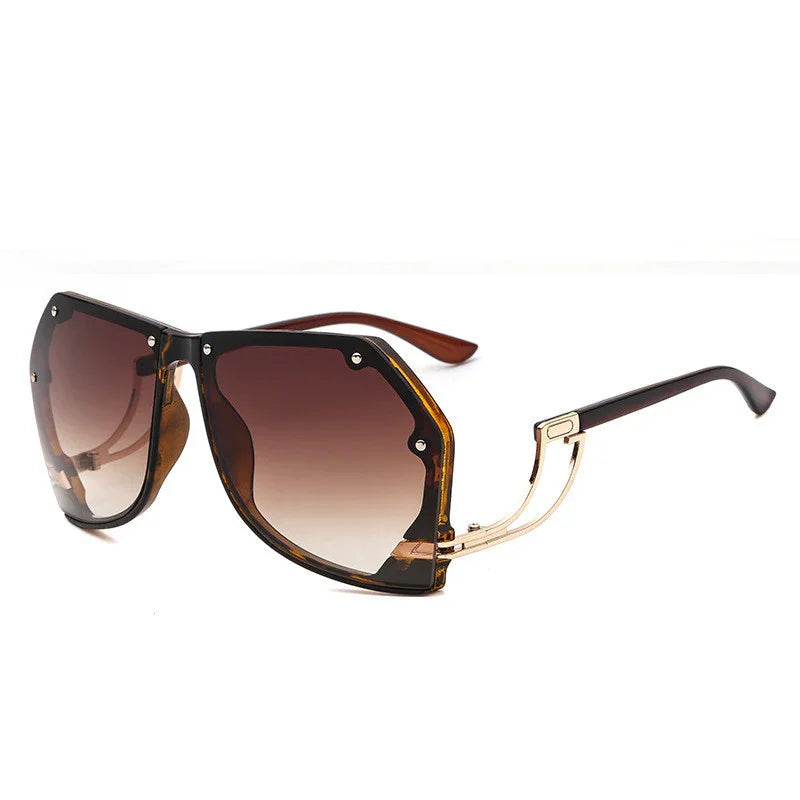 Stylish oversized square sunglasses with gradient brown lenses and gold-accented black and tortoiseshell frame