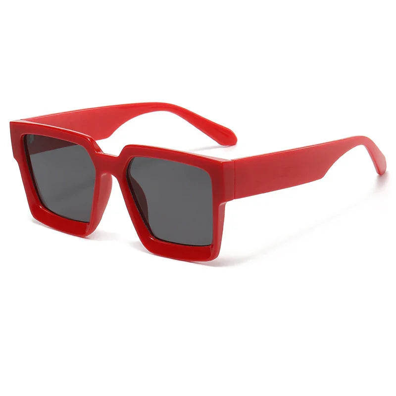 Red thick square frame sunglasses with dark lenses on white background