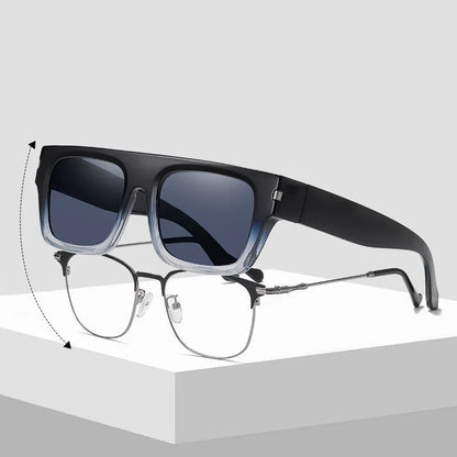 Convertible glasses with clear lower frame and dark tinted clip-on sunglasses, displayed on white surface
