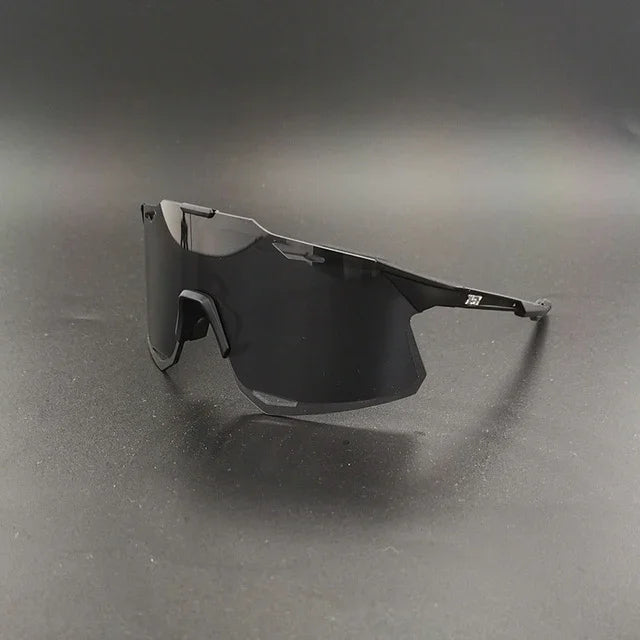 Black sport wraparound sunglasses with large shield lens on a dark background