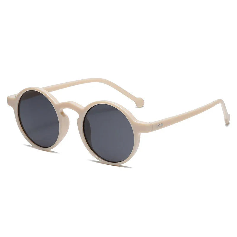 Beige round frame sunglasses with dark lenses on white background