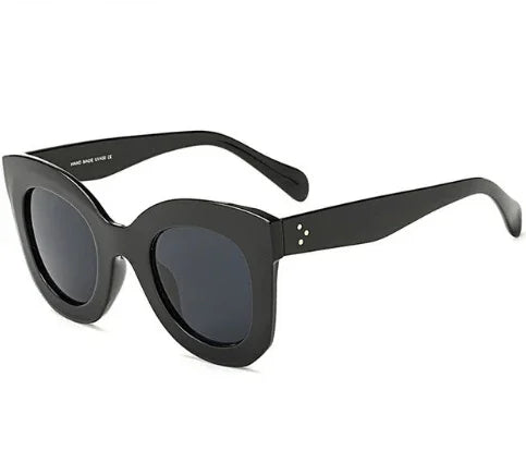 black oversized cat-eye sunglasses with dark lenses and thick frames