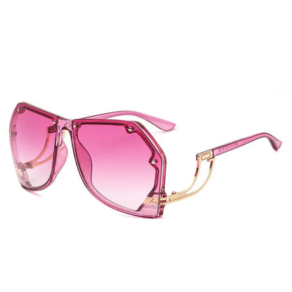 Stylish oversized pink gradient sunglasses with geometric transparent frame and gold temple arms