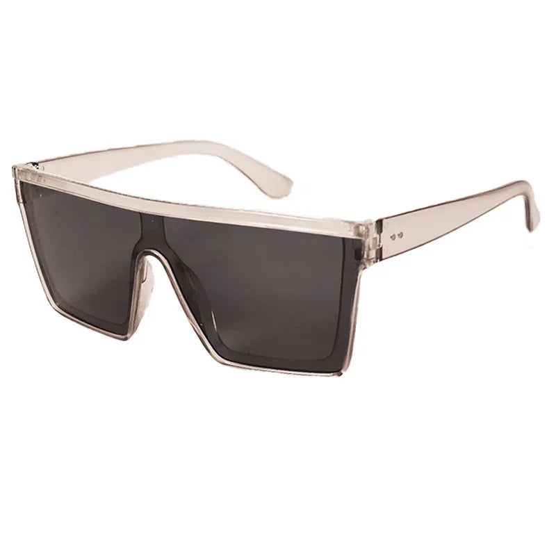 Futuristic oversized square sunglasses with transparent beige frame and dark tinted lenses