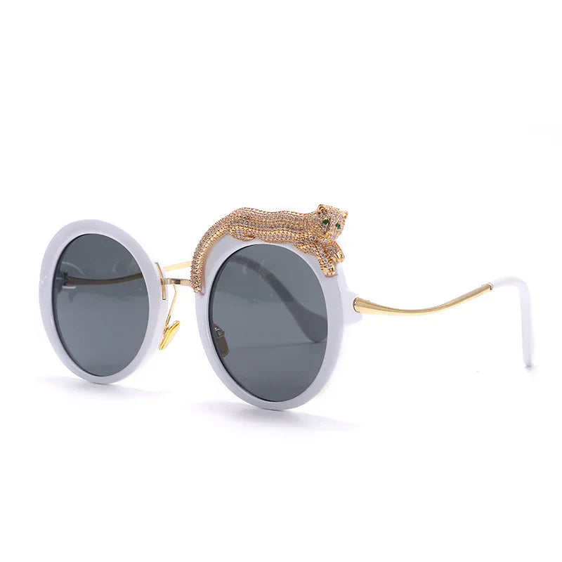 Round gray lens sunglasses with white frame and golden leopard decoration on top