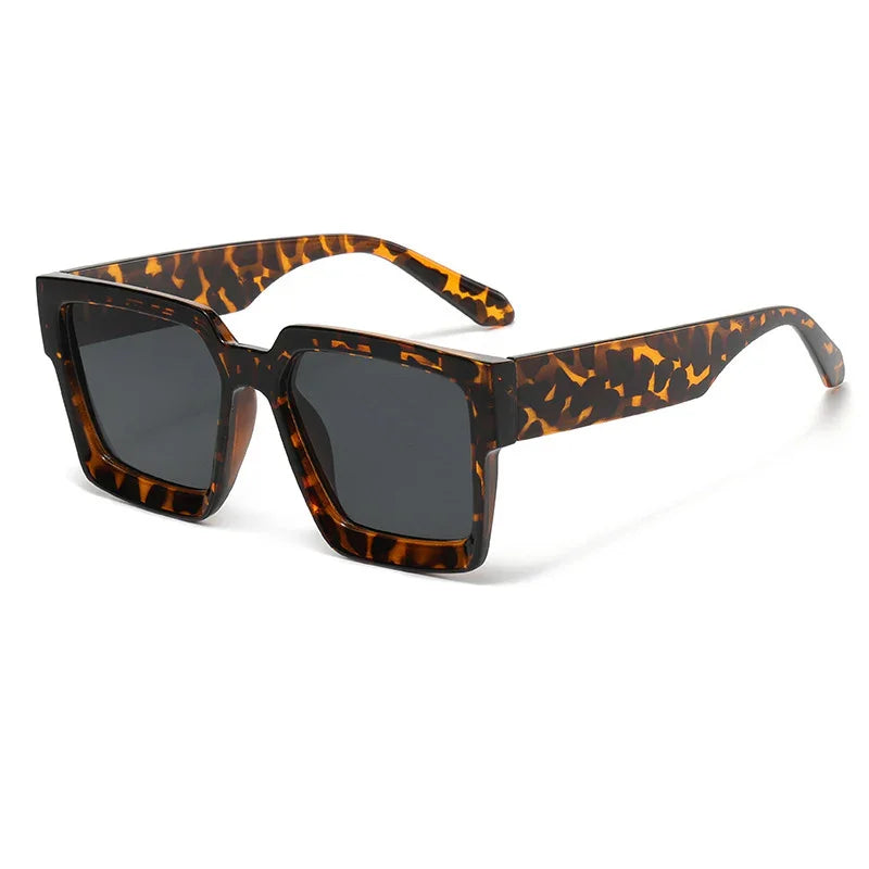 Stylish square tortoiseshell sunglasses with dark lenses on white background