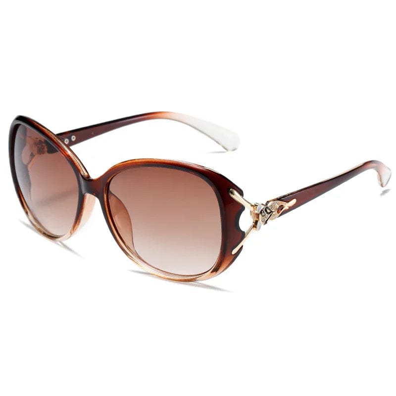 Brown gradient oversized sunglasses with butterfly-shaped metal accents on temples