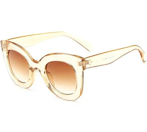 Transparent beige cat-eye sunglasses with gradient brown lenses on white background