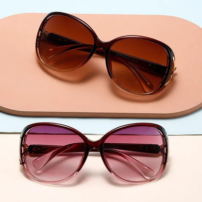 Two oversized sunglasses with gradient lenses in brown and pink on beige and light blue background