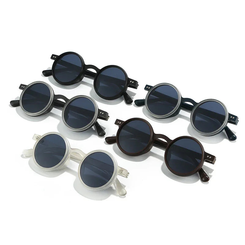Five pairs of round vintage-style sunglasses with dark lenses in black, brown, and white frames on white background