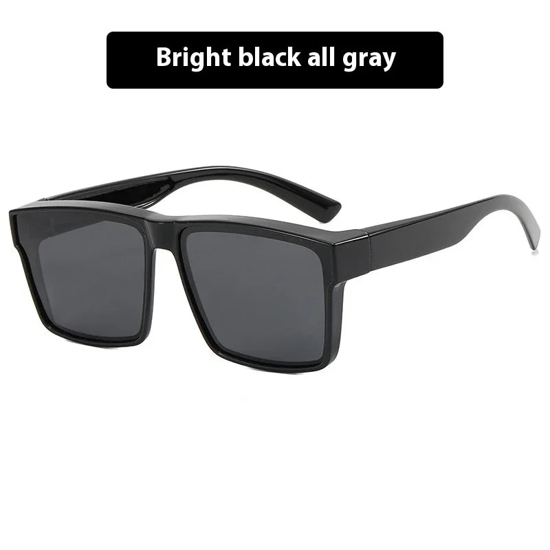 Bright black rectangular sunglasses with wide gray lenses on a white background
