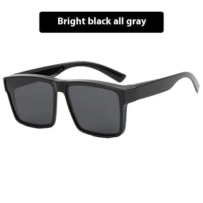 Bright black rectangular sunglasses with wide gray lenses on a white background