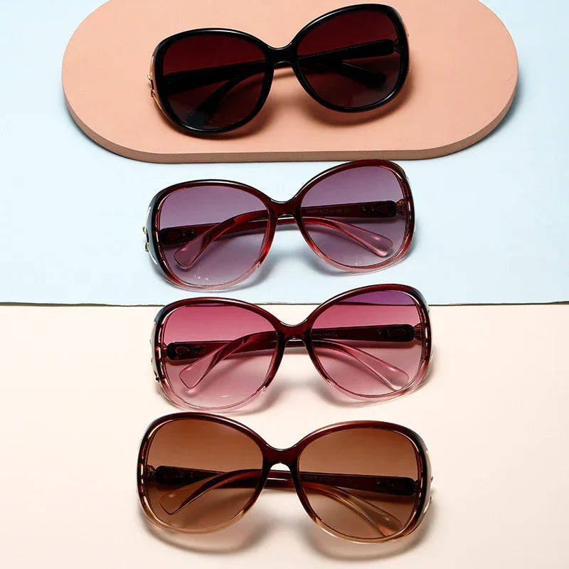 Four pairs of women's oversized sunglasses in gradient and solid brown and pink tones on pastel backgrounds