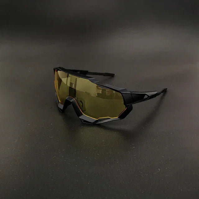 Futuristic sports sunglasses with yellow tinted shield lens on black background