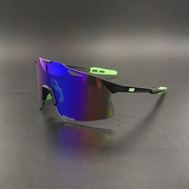 Sport sunglasses with blue mirrored shield lens and black frame, green ear tips on dark background