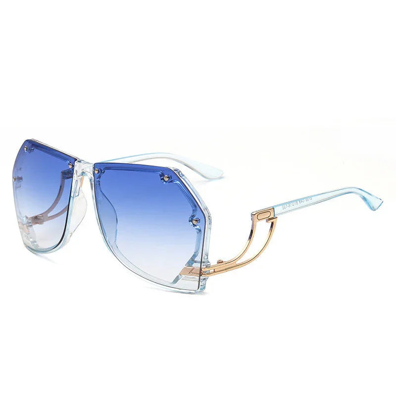 Stylish oversized sunglasses with blue gradient lenses and transparent frames with gold accents