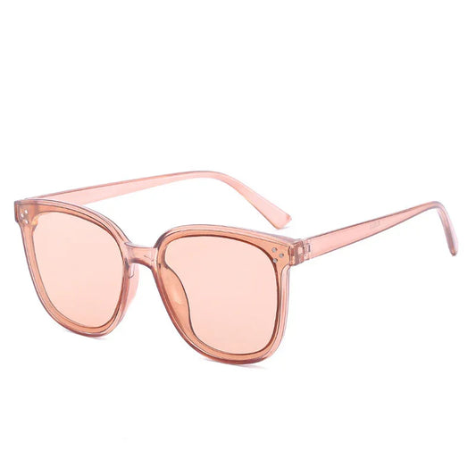 Stylish translucent pink cat-eye sunglasses with matching tinted lenses on white background