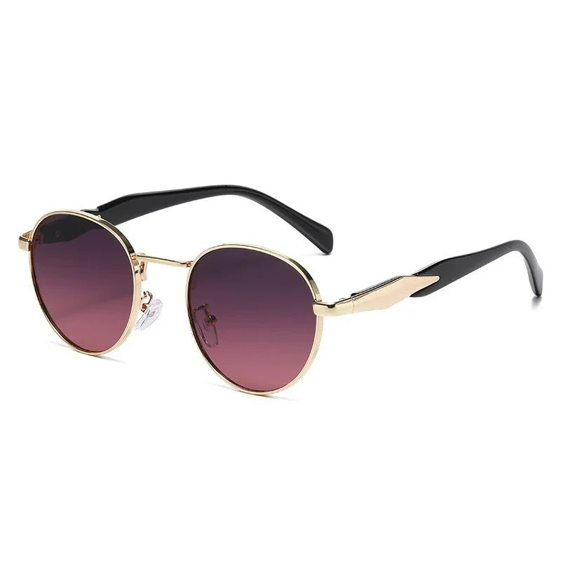 Round sunglasses with gold metal frame, purple gradient lenses, and black temple arms