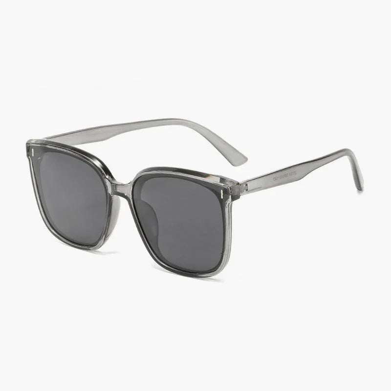 Transparent gray frame sunglasses with dark tinted lenses on white background