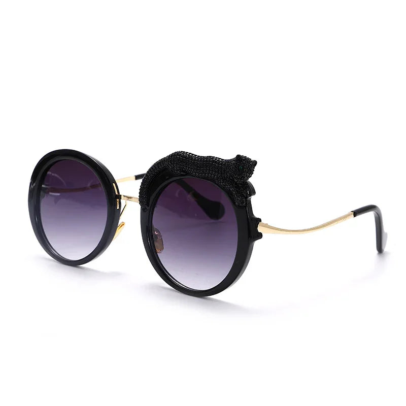 Round black sunglasses with gradient purple lenses and a decorative black cat figure on the frame