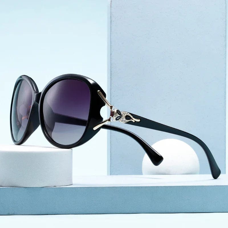 Black oversized round sunglasses with gradient lenses and decorative rhinestone detail on temples
