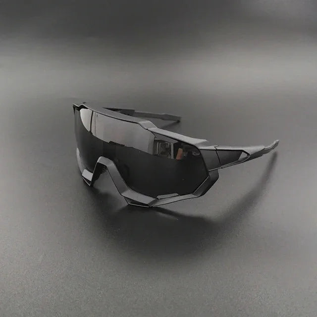 Futuristic black wraparound sunglasses with geometric frame on dark surface