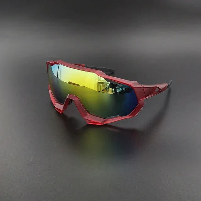 Red sports sunglasses with yellow mirrored lenses on a black background