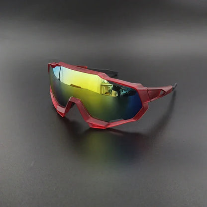 Red sports sunglasses with yellow mirrored lenses on a black background